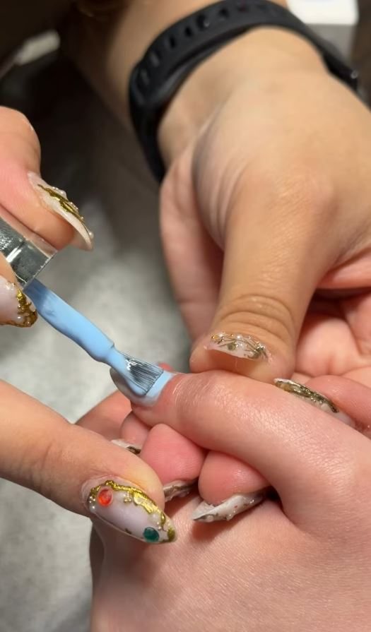 Fine nail art being applied